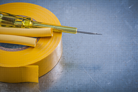 Yellow insulating tape electric cables insulated turnscrew construction concept.