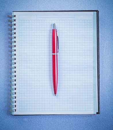 Red ballpoint pen blank note pad office concept.の写真素材