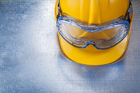 Plastic goggles building helmet on metallic background.の写真素材