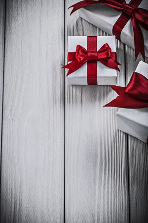 Gift boxes with tied ribbons on wooden board holidays concept.の写真素材