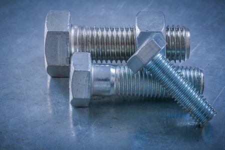 Steel screw-nuts with bolt on metallic background maintenance concept.の写真素材