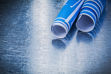 Stack of blue construction plans on metallic background building concept.の写真素材