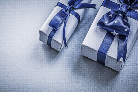 Assortment of wrapped giftboxes on blue background holidays concept.の写真素材