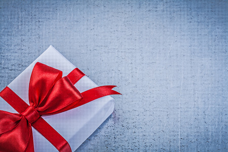 Present box with red bow on metallic background holidays concept.の写真素材