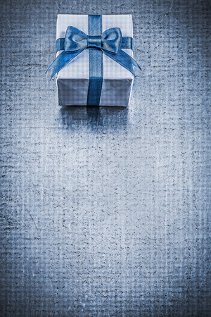 Giftbox blue bow on metallic background vertical image holidays concept.の写真素材