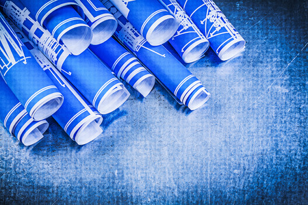 Pile of blue blueprints on metallic background construction concept.の写真素材