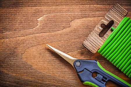 Soft twist tie garden shears on wooden board gardening concept.の写真素材