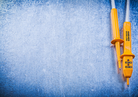 Electrical tester on scratched metallic background copy space.の写真素材