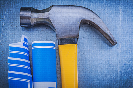 Composition of blue construction plans claw hammer on metallic background.の写真素材