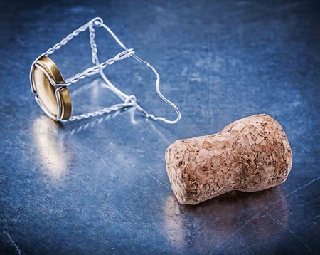 Cork stopper with twisted wire on metallic background.