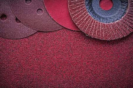 Abrasive flap wheels grinding discs on emery paper.