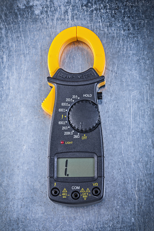 Digital ammeter on metallic background.