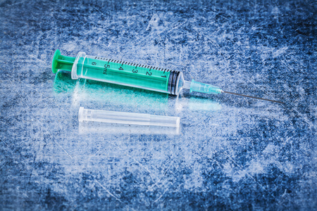 Medical syringe surgical needle on metallic background medicine concept.の写真素材