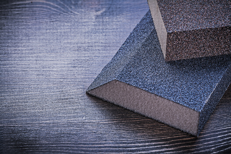 Sanding sponges on vintage wooden board abrasive tools.の写真素材