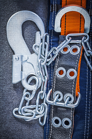 Construction safety strap with metal chain on black background maintenance concept.の写真素材