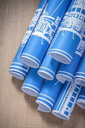 Engineering drawings on wooden board top view construction concept.の写真素材