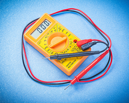 Yellow electrical digital gauge on blue background electricity concept.