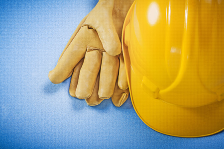 Building helmet leather safety gloves on blue background construction concept.の写真素材