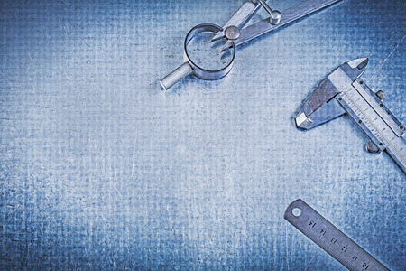 Metal construction divider ruler vernier caliper on metallic background.の写真素材