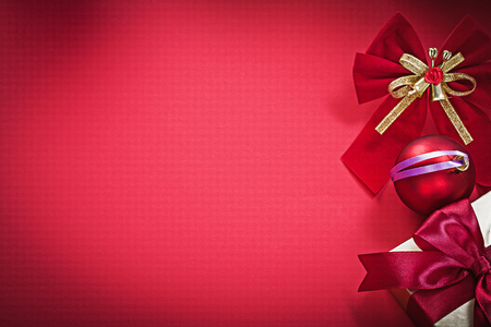 Christmas ball bow present box on red background holidays concept.の写真素材