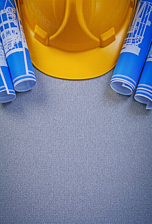 Building helmet blue blueprints on grey background copy space construction concept.の写真素材