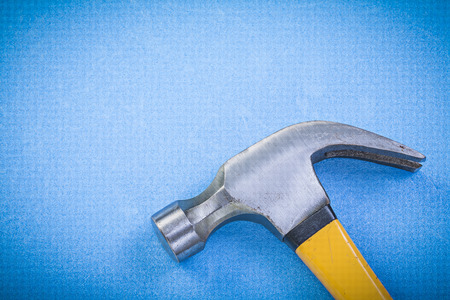 Metal claw hammer on blue backgroundの写真素材