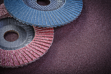 Abrasive flap wheels on sandpaper sheet top view.の写真素材