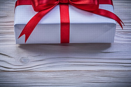 Gift box on wooden board front view holidays concept.の写真素材