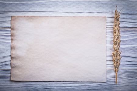 Vintage paper sheet for menu rye ear on wooden board.の写真素材
