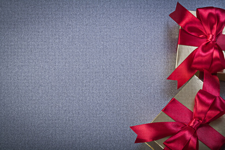 Giftboxes with red tapes on grey background holidays concept.