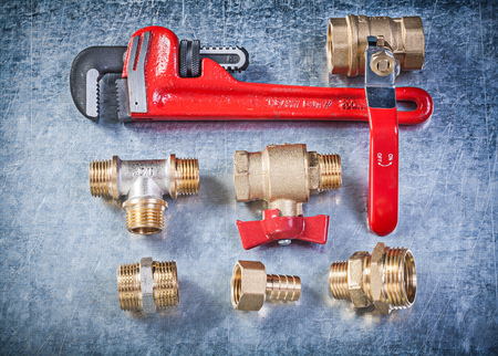 Collection of plumbing brassware on metallic background directly above construction concept.の写真素材