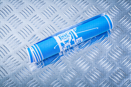 Blue engineering drawings on channeled metal plate construction concept.の写真素材