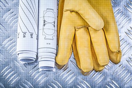 Engineering drawings leather safety gloves on fluted metal sheet construction concept.の写真素材