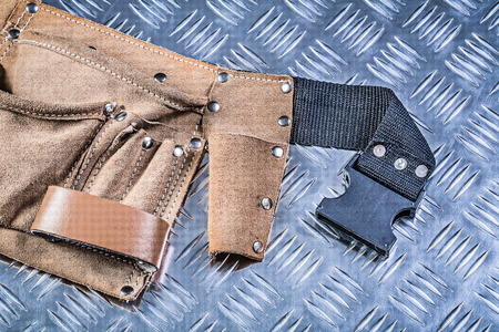 Leather tool belt on fluted metal background construction concept.の写真素材