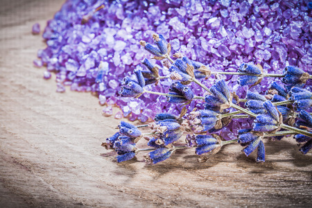 Bunch of lavender scented sea salt on wooden board spa treatment concept.の写真素材