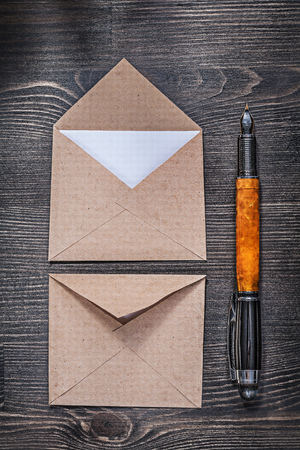 Vintage post envelopes letter fountain pen on wooden board.の写真素材