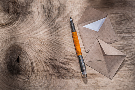 Vintage envelopes fountain pen on wooden board.の写真素材