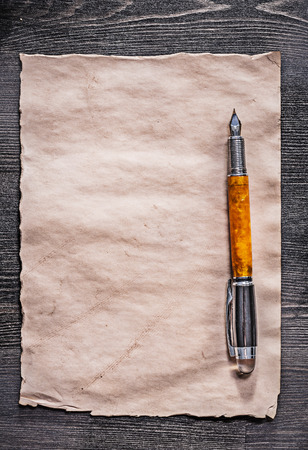 Vintage sheet of paper fountain pen on wooden board.の写真素材