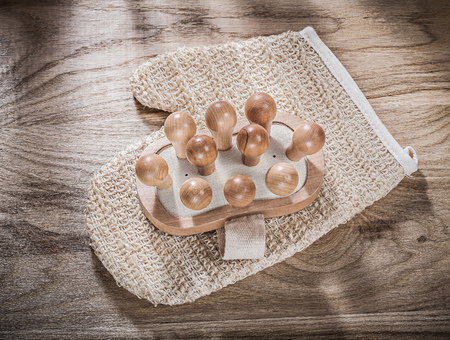 Massager body scrubber on wooden board healthcare concept.の写真素材