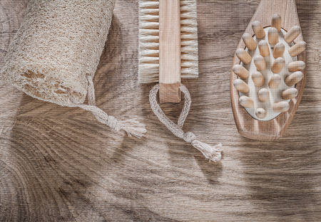 Composition of scrubbing loofah massager bath brush on wooden board spa treatment concept.の写真素材
