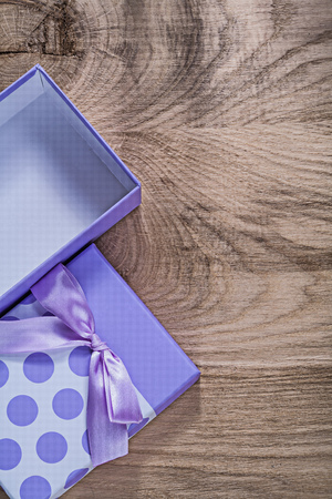 Purple present box on wooden board top view celebrations concept.の写真素材