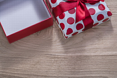 Red opened gift box on wooden board horizontal version celebrations concept.