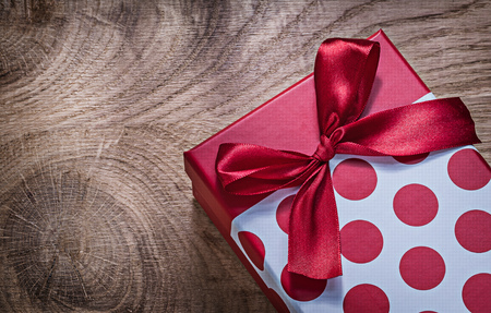 Red packed gift box on wooden board celebrations concept.