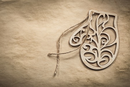 Vintage wooden mitten string on paper background holidays concept.の写真素材