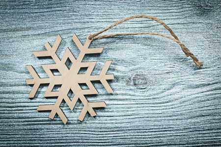 Close up view of vintage wooden snowflake string on wood board holidays concept.の写真素材