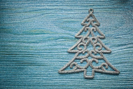 Silver Christmas tree decoration on wood board top view celebrations concept.の写真素材