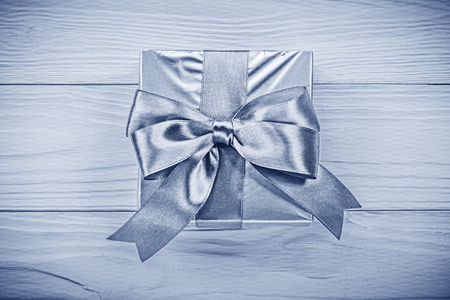 Present box on wooden board directly above holidays concept.の写真素材