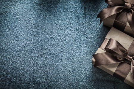 Present boxes with brown knots on black background celebrations concept.の写真素材