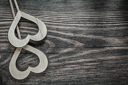 Composition of white wooden hearts on vintage wood board holidays concept.の写真素材