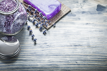 Handmade soap lavender aromatic bath salt jar cover on wooden board spa treatment concept.の写真素材